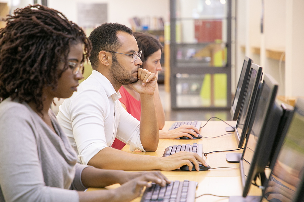 Multiracial group of students training on computer ERP software